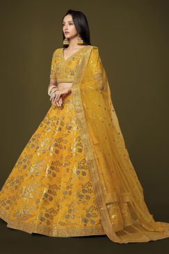 Alternative view of yellow lehenga arrives with a similar color slub silk material choli decorated with sequins work and zari work