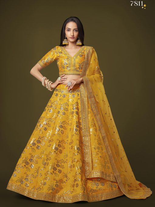 yellow lehenga arrives with a similar color slub silk material choli decorated with sequins work and zari work